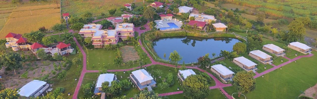 Sterling Kanha resort grounds and pond from above