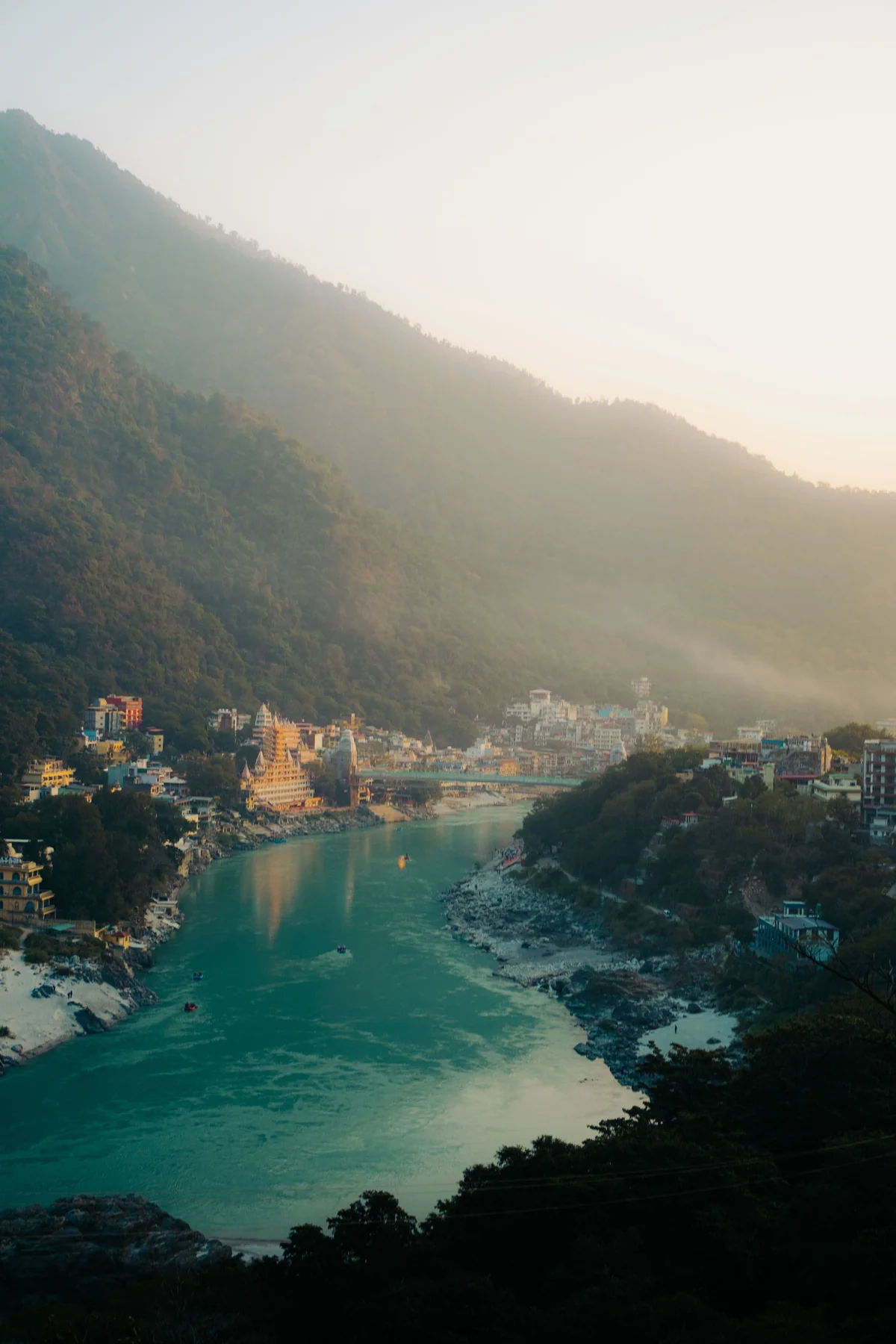 Morning light on the Ganga and hills in Rishikesh, illustrating a quiet riverside break