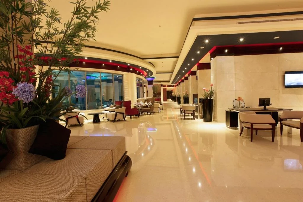 Ramada Alleppey lobby with seating and polished floors.