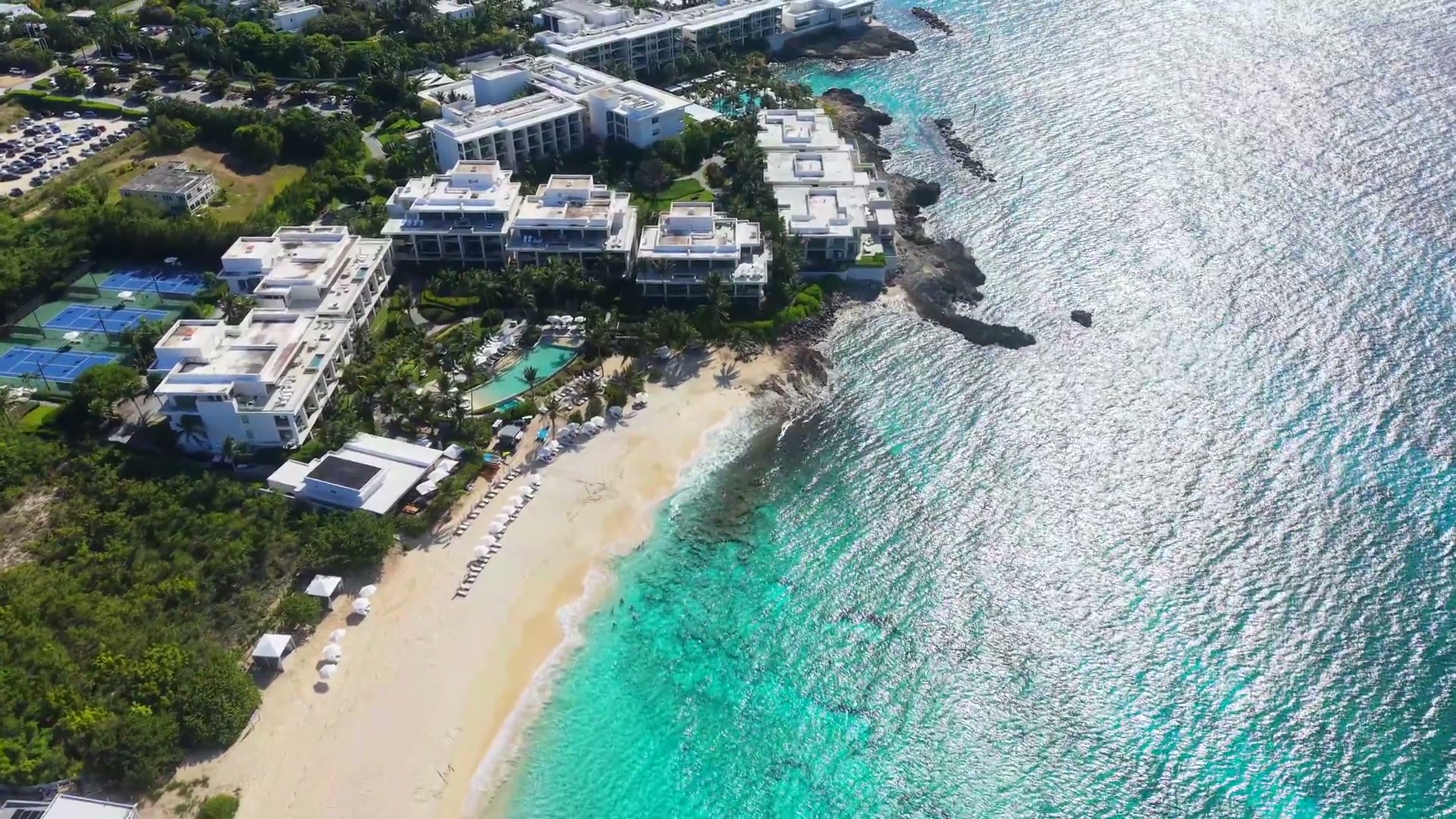 Illustrative resort beside a tropical shoreline
